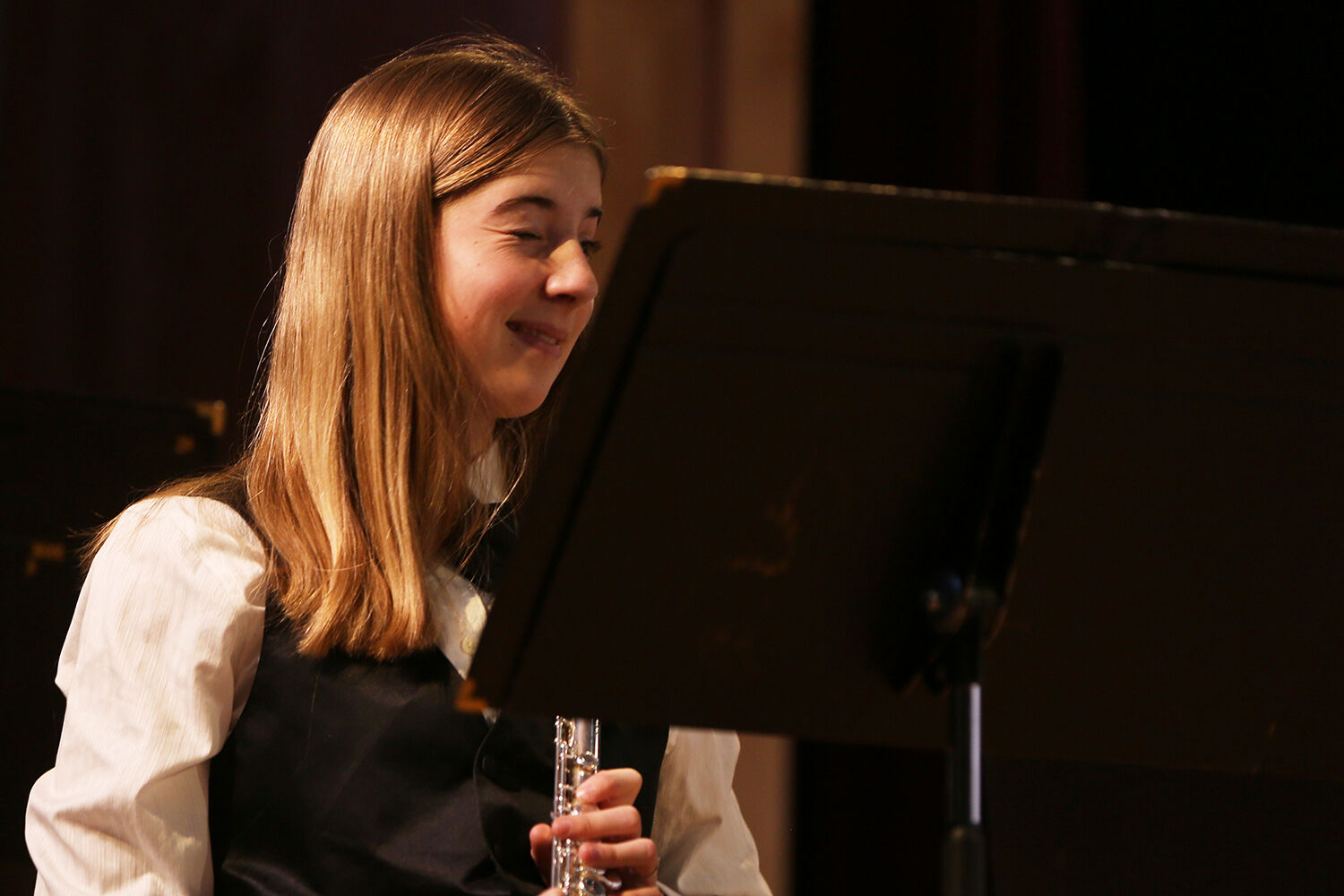 Elizabeth Farris winks back and forth with another member flutist